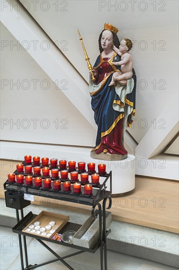 Madonna figure with baby Jesus and sacrificial candles