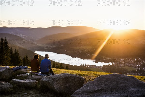Older couple at Hochfirst with view to Titisee and Feldberg at sunset