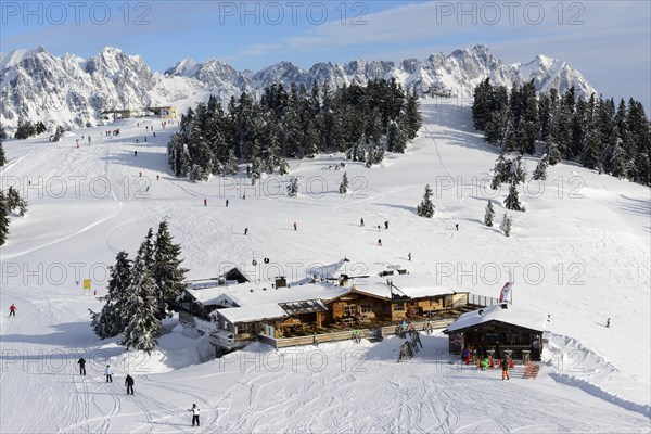 Mountain restaurant Skihutte Jochstub'n in front of the mountain range Wilder Kaiser in the ski area Wilder Kaiser-Brixental