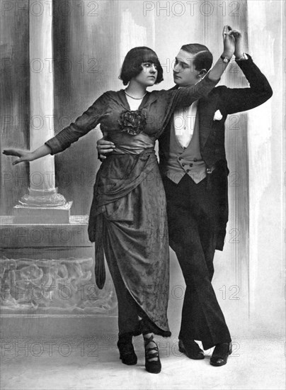 Couple dances with serious gaze