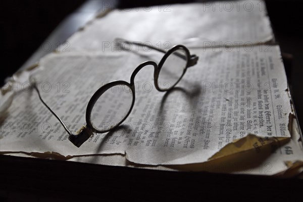 Old spectacles on historic book
