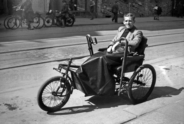 Photographer Karl Heinz Mai in a wheelchair