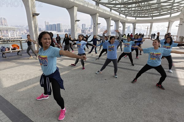 Southeast Asian women dancing Zumba on pier