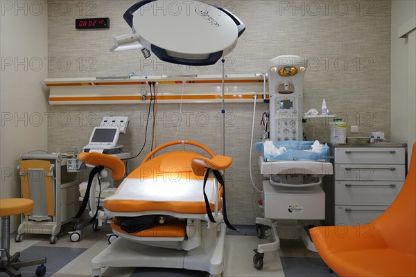 Empty modern delivery room with birthing chair