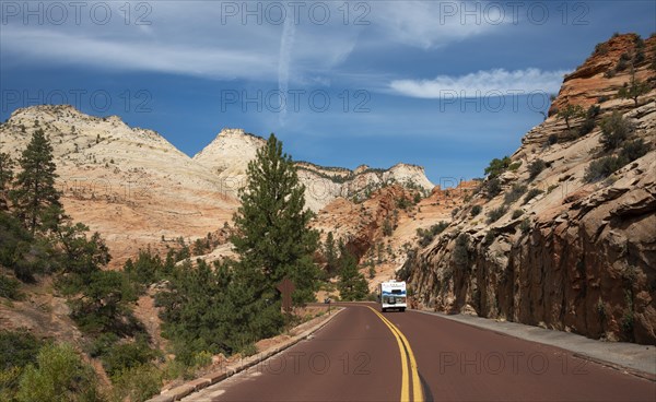 Caravan on road through mountain landscape