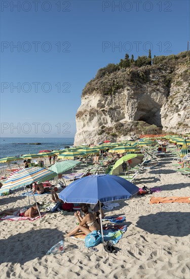 Many people with colorful sunshades at Lido Isola Bella Beach