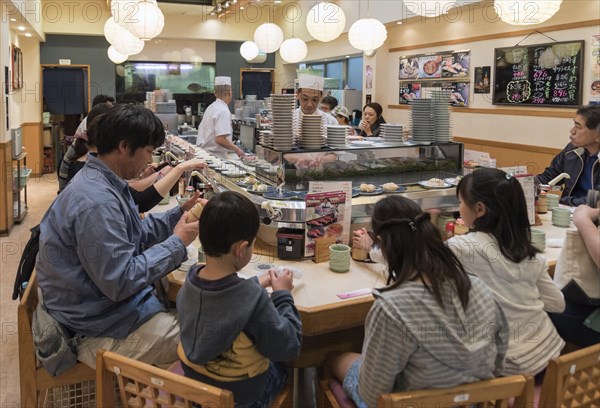 Kaiten-zushi restaurant serving sushi on rotating conveyor belt