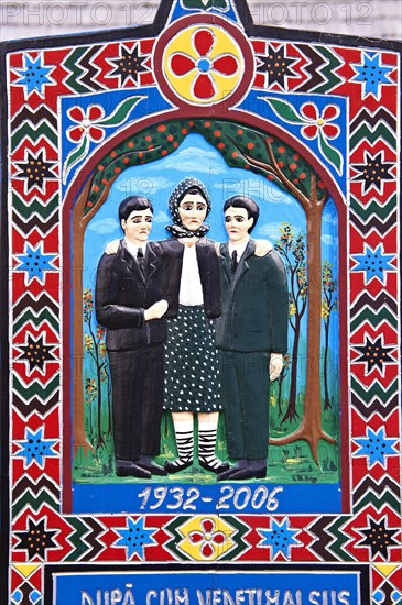Tombstone of a mother showing her with her sons