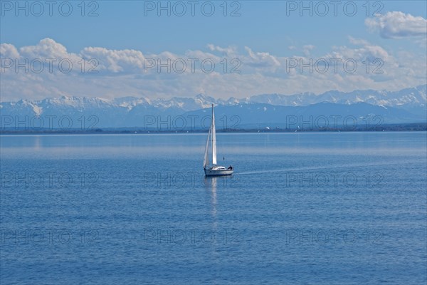 Lake Ammer with sailboat and the snow-covered Alpine peaks in the background