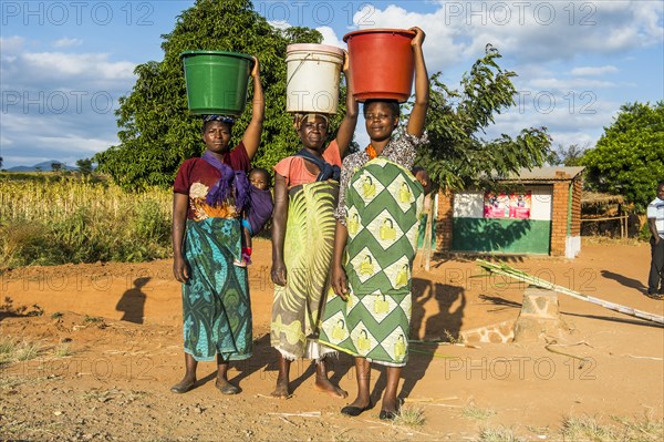 Local women carrying buckets on their head