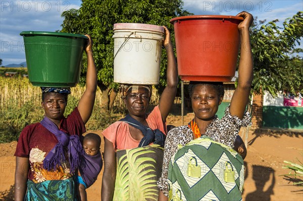 Local women carrying buckets on their head
