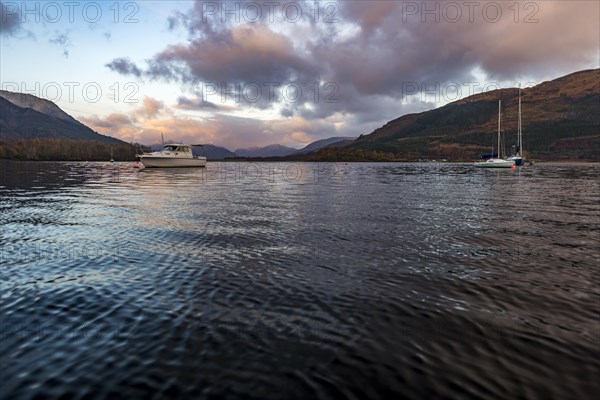 Boats with Loch Linnhe at sunrise with coloured clouds