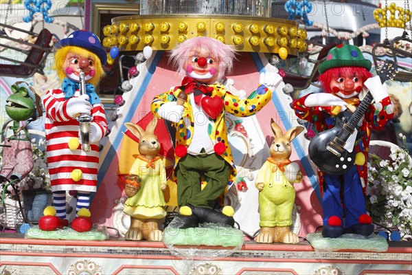 Clowns as decoration on a carousel