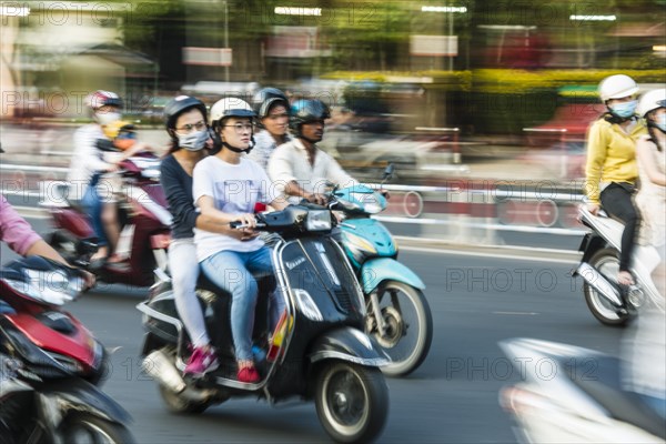 Scooter drivers in heavy traffic
