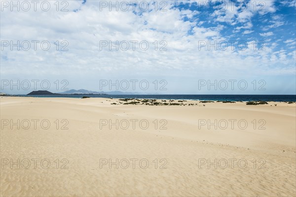 Dunes against blue sea