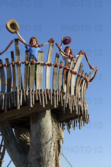 Boy and girl standing on lookout tower at Cape Kamenjak
