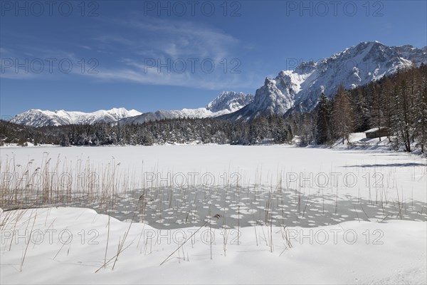 Frozen lake Lautersee in front of Karwendel Mountains