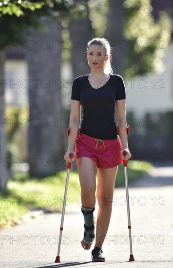 Young woman with crutches
