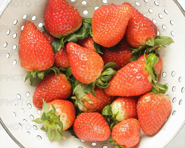 Fresh strawberries in a colander