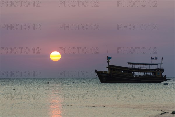 Diving boat in sea at sunset