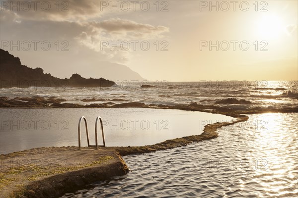 Natural swimming pool at sunset