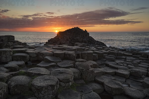Basalt columns by the coast at sunset