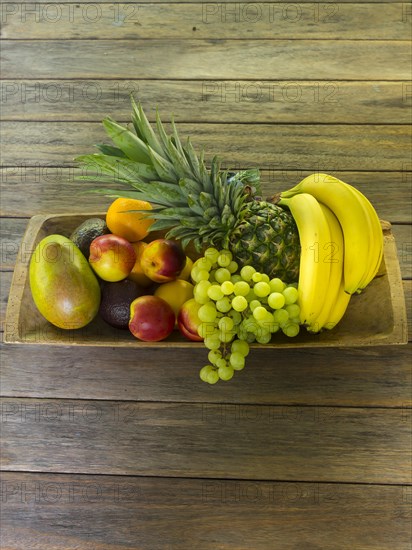 Wooden bowl full of fruit