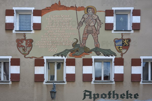 Mural with inscription and the St. George and the Dragon on the town pharmacy