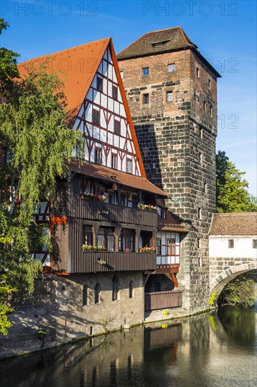 Old half-timbered house and water tower by the river Pegnitz
