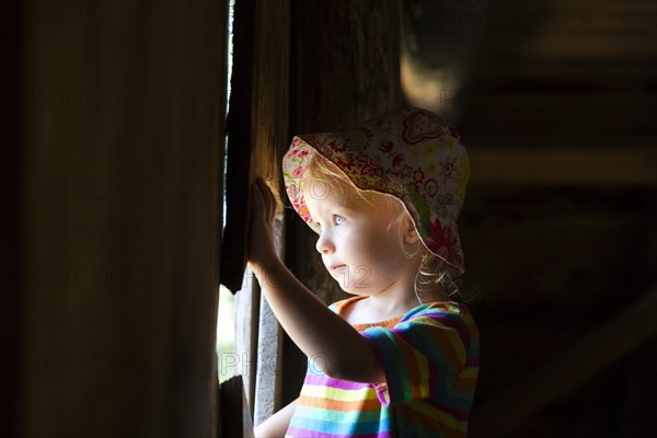 Toddler looking out of a window