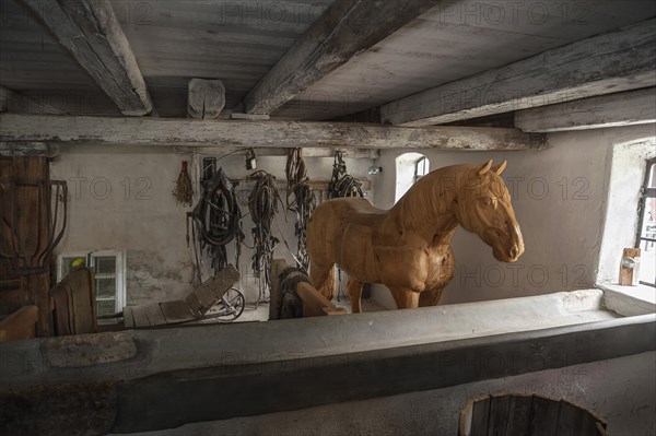 Wooden horse in the horse barn