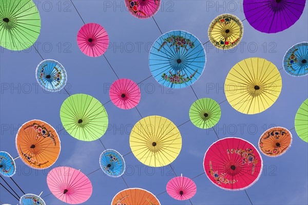 Many colourful umbrellas suspended in mid-air