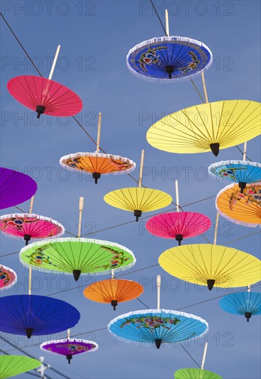 Many colourful umbrellas suspended in mid-air
