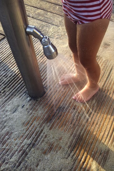 Girl washing sand off her feet
