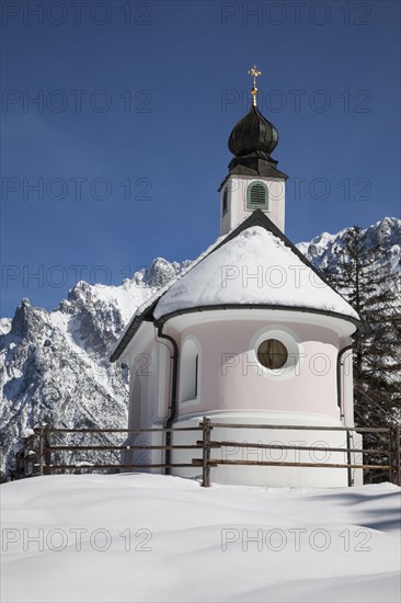 Maria-Konigin Chapel in the snow in front of the Karwendel Mountains