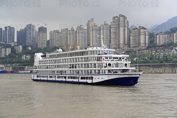 Cruise ship on the Yangtze River with skyscrapers