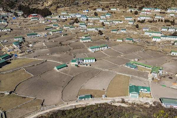 Spread out agricultural village with fields and farmers houses in a high valley