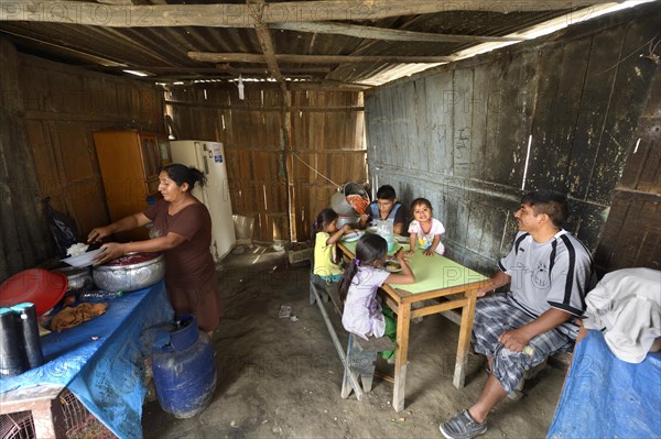 Woman cooking for her family in simple kitchen