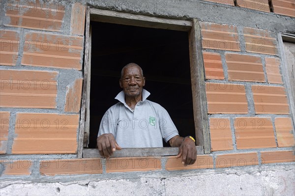 Old man looking out of window