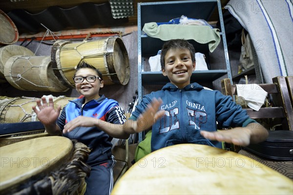 Boys drumming happily