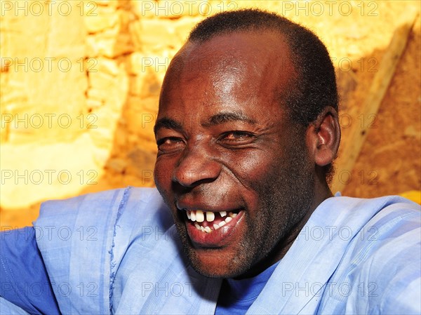 Portrait of a laughing man wearing a blue boubou