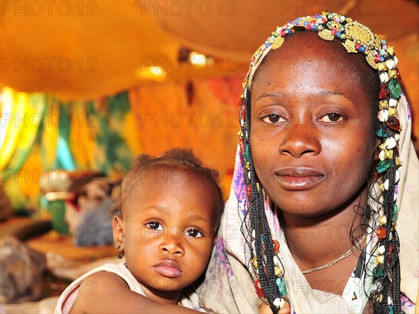 Woman with headdress with her child