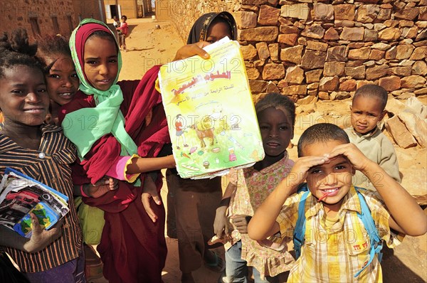 Children showing a textbook