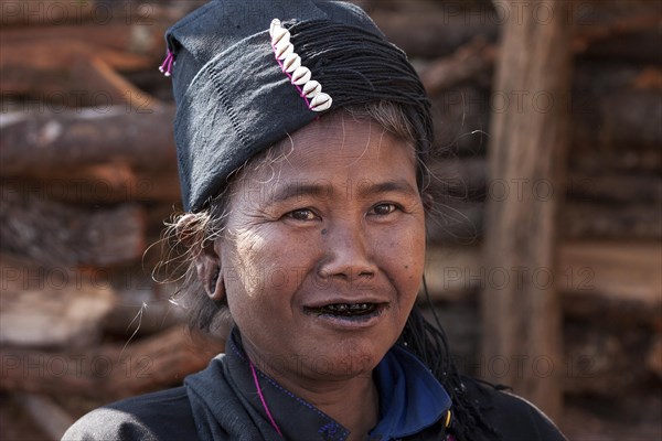 Native woman in typical clothing and headgear from the Ann tribe in a mountain village at Pin Tauk