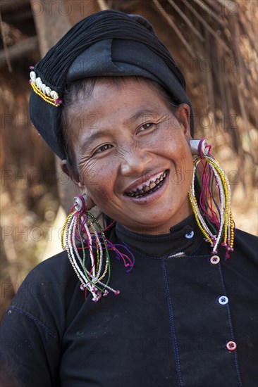 Native woman in typical clothing and headgear from the Ann tribe in a mountain village at Pin Tauk