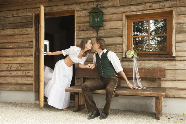 Wedding couple in front of an alpine mountain hut