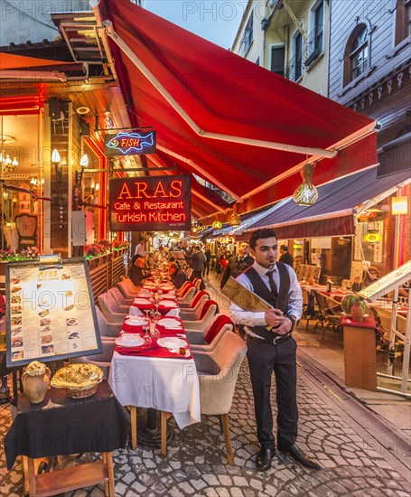 Waiter holding a menu