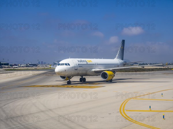 Vueling airliner rolling on the apron of the airport