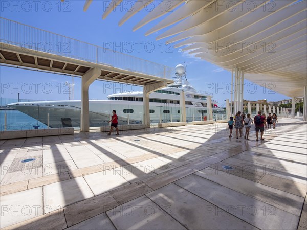 Promenade at the port with a yacht