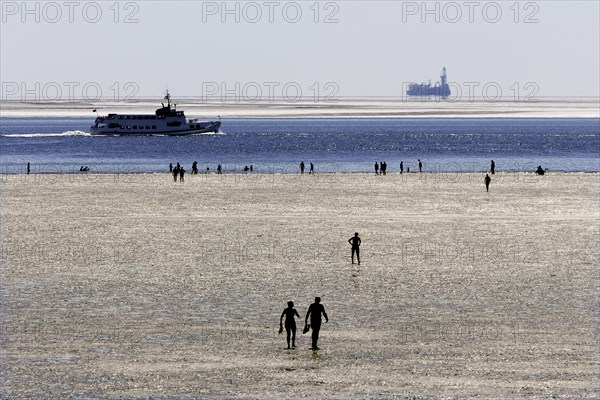 Strollers walking at low tide on the foreshore